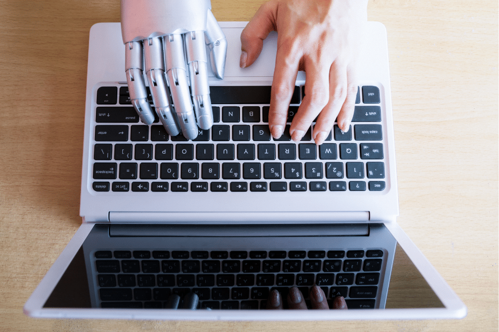 robot hand and human hand on laptop fashion seo aio